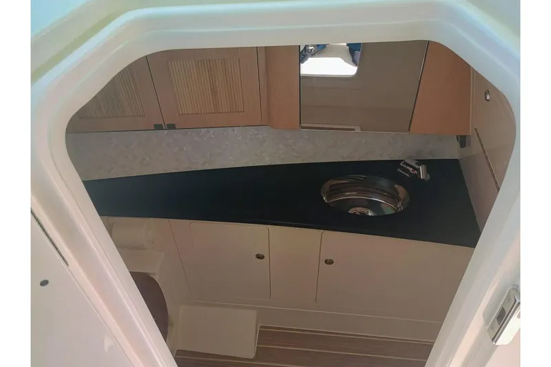 Slide: The Image of Interior view of 2025 Grady-White Freedom 345 boat cabin with sink and cabinets. - 11