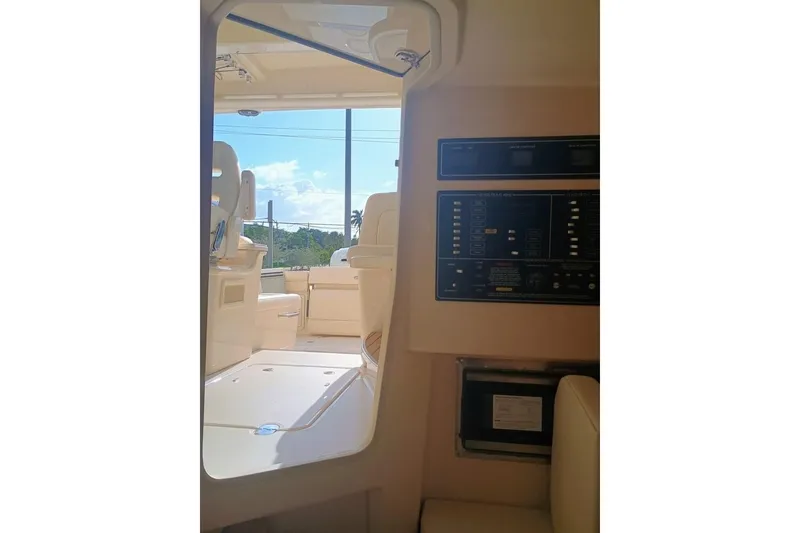 Slide: The Image of Interior view of 2025 Grady-White Freedom 345 boat, showcasing control panel and seating area. - 12