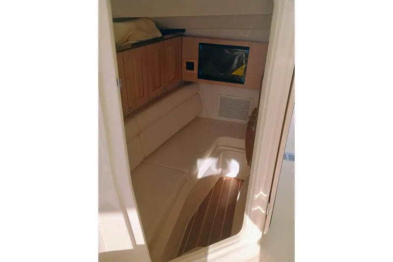 Slide: The Image of 2025 Grady-White Freedom 345 cabin interior with seating and wooden cabinetry. - 14