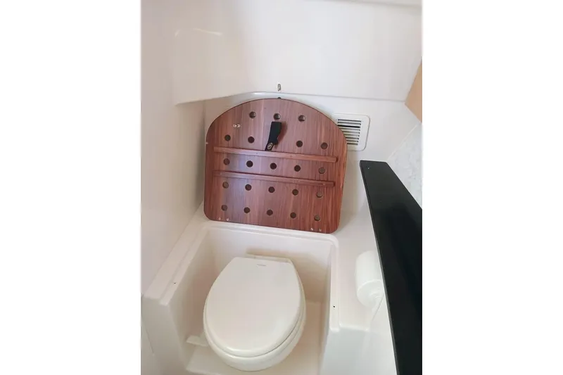 Slide: The Image of 2025 Grady-White Freedom 345 boat interior with compact marine toilet. - 17