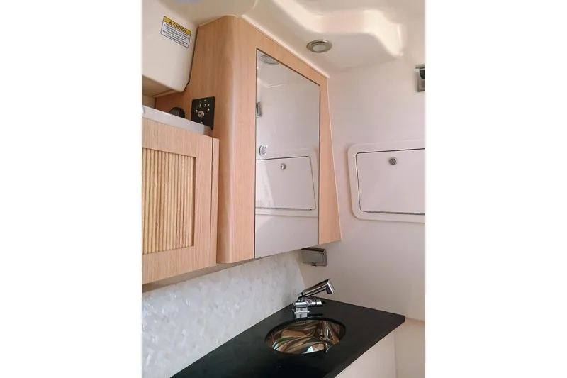 Slide: The Image of 2025 Grady-White Freedom 345 boat interior with modern sink and mirror. - 18
