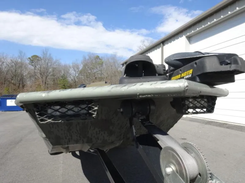 Slide: The Image of 2014 War Eagle 1542 boat with Minn Kota motor on trailer, outdoors. - 13