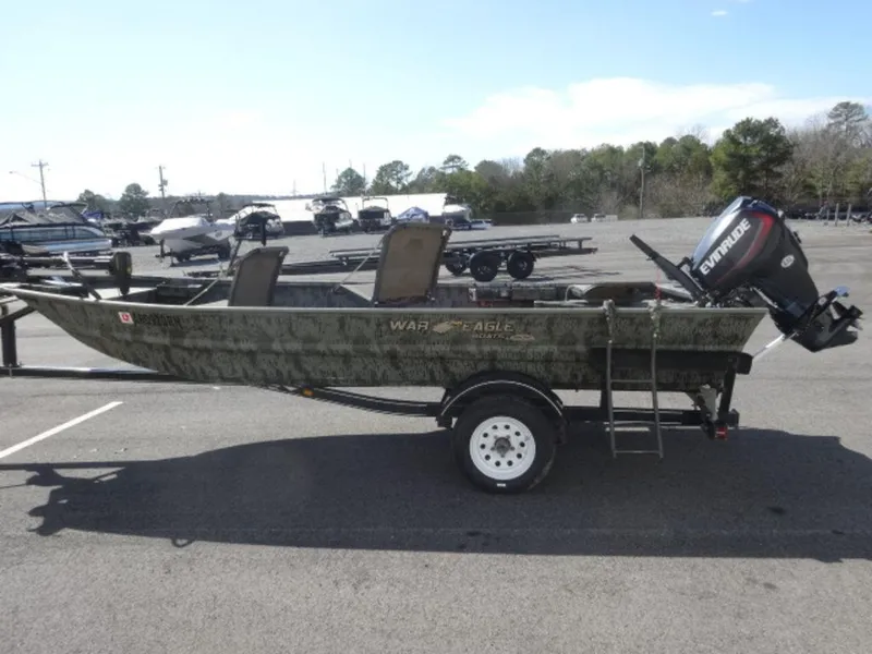 Slide: The Image of 2014 War Eagle 1542 boat with Evinrude motor on trailer in parking lot. - 3