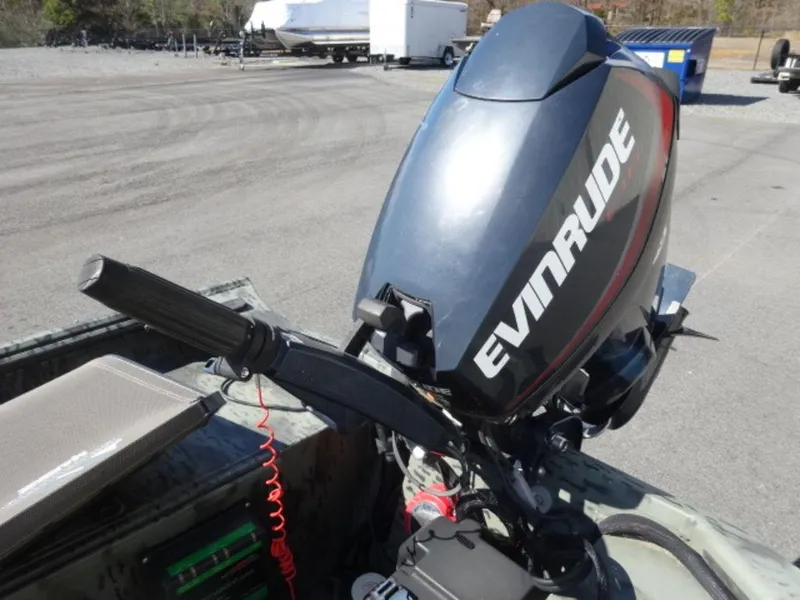 Slide: The Image of 2014 War Eagle 1542 boat with Evinrude outboard motor in a parking lot. - 5