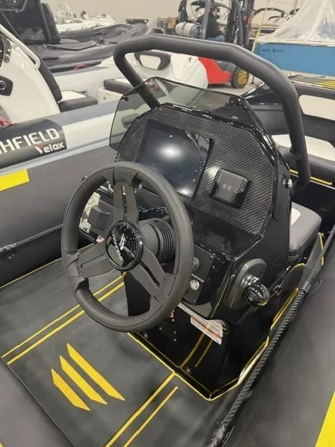 Slide: The Image of 2025 Highfield Velox 420 boat dashboard with steering wheel and control panel. - 10