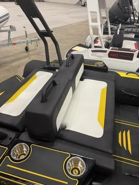 Slide: The Image of 2025 Highfield Velox 420 boat interior with black and yellow seating and cup holders. - 9