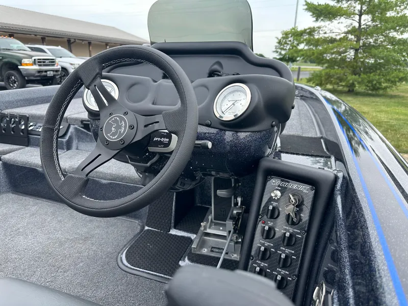Slide: The Image of 2025 Phoenix 819 ZXL boat dashboard with steering wheel and control panel. - 15