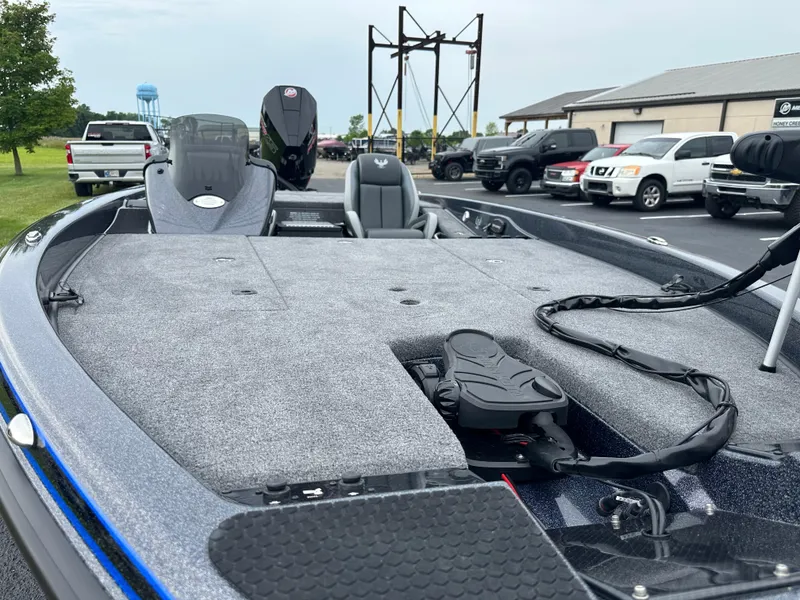 Slide: The Image of 2025 Phoenix 819 ZXL boat with spacious deck and modern features in a parking lot. - 16