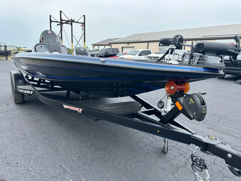 Slide: The Image of 2025 Phoenix 819 ZXL boat on trailer, parked outdoors, showcasing sleek design and modern features. - 4