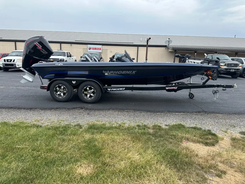 Slide: The Image of 2025 Phoenix 819 ZXL boat on trailer, parked outdoors near dealership. - 5