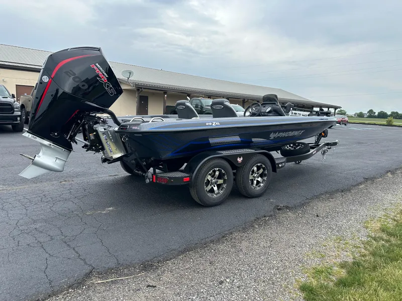 Slide: The Image of 2025 Phoenix 819 ZXL boat on trailer, parked outdoors, featuring sleek design and powerful engine. - 6