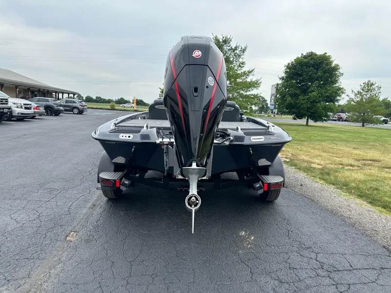 Slide: The Image of 2025 Phoenix 819 ZXL boat, rear view, parked on asphalt near grassy area. - 7