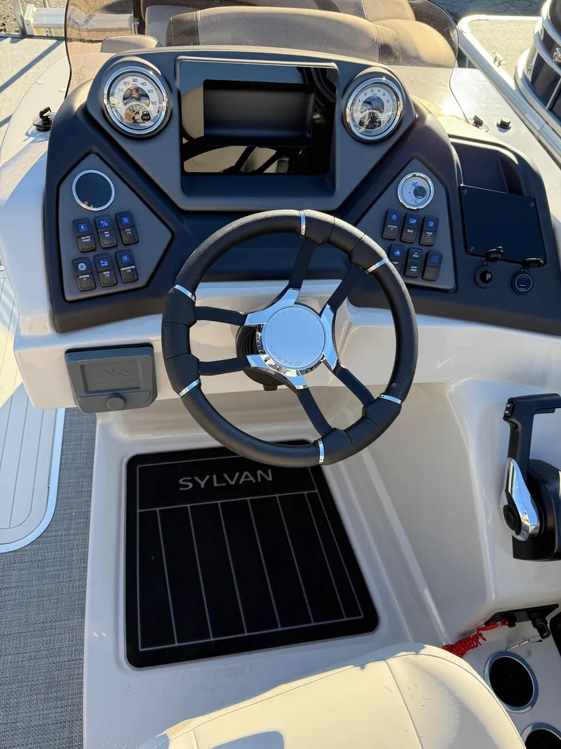 Slide: The Image of 2025 Sylvan L-3 LZ boat dashboard with steering wheel and control panel. - 19