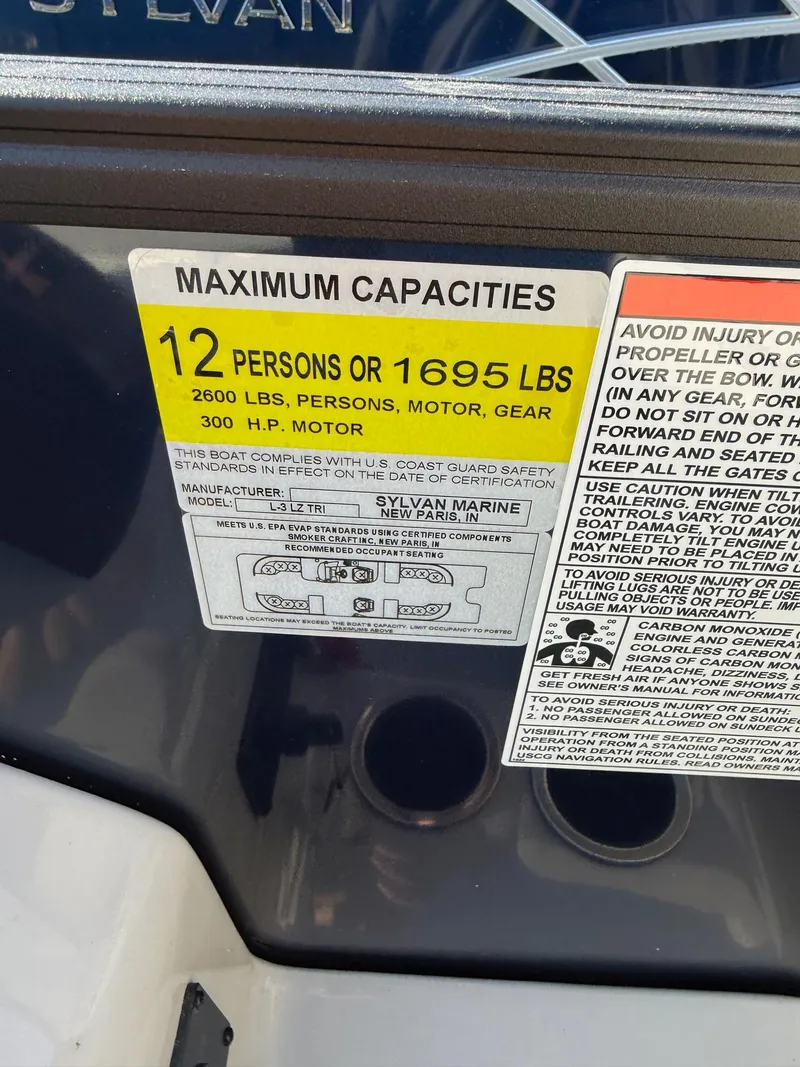 Slide: The Image of 2025 Sylvan L-3 LZ boat capacity label, 12 persons or 1695 lbs, 300 HP motor. - 23