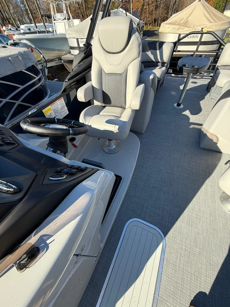 Slide: The Image of 2025 Sylvan L-3 LZ boat interior with modern seating and steering wheel. - 6