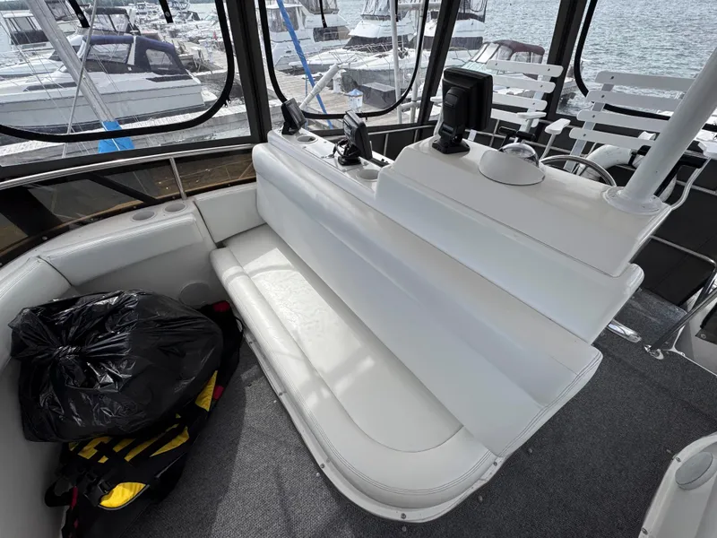 Slide: The Image of 1997 Silverton 41 Convertible boat interior with white seating and navigation equipment. - 12