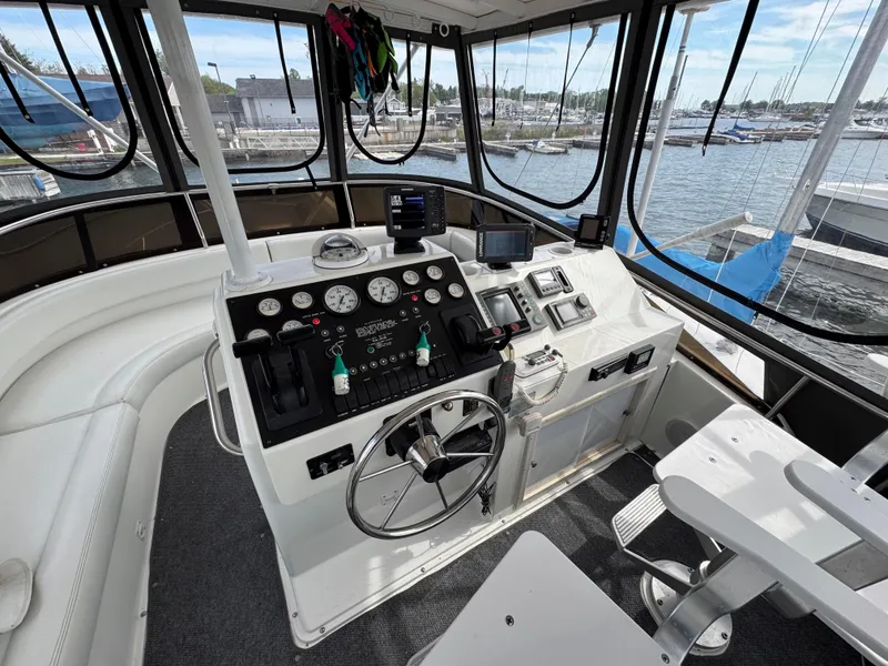 Slide: The Image of Cockpit of a 1997 Silverton 41 Convertible boat with steering wheel and control panel. - 14