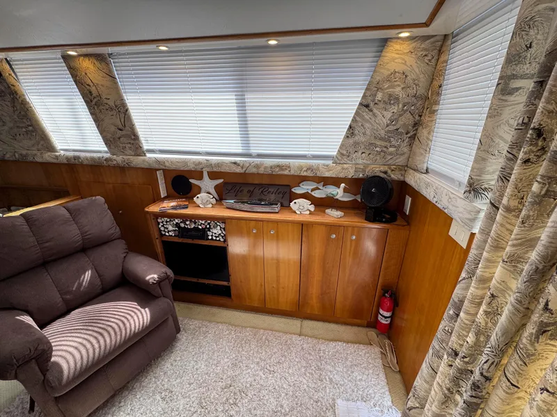 Slide: The Image of Interior of 1997 Silverton 41 Convertible yacht with cozy seating and wooden cabinetry. - 20