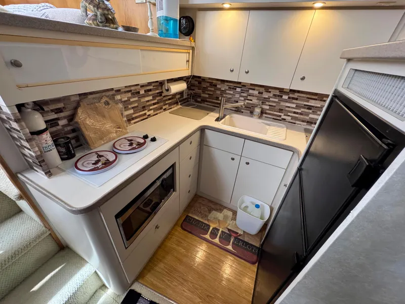 Slide: The Image of 1997 Silverton 41 Convertible yacht kitchen with modern appliances and stylish backsplash. - 24