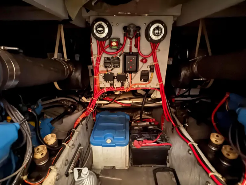 Slide: The Image of Engine room of a 1997 Silverton 41 Convertible boat, featuring wiring and batteries. - 29