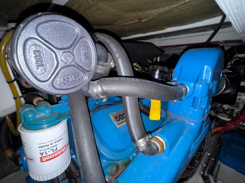 Slide: The Image of Engine compartment of a 1997 Silverton 41 Convertible boat, featuring hoses and components. - 30