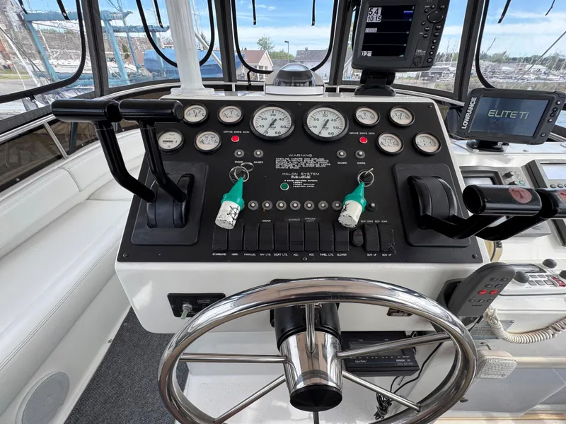 Slide: The Image of 1997 Silverton 41 Convertible helm with gauges, controls, and navigation equipment. - 9