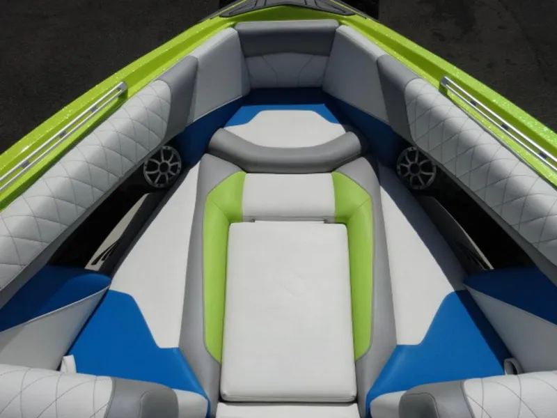 Slide: The Image of 2018 Tigé Z3 boat interior with vibrant green, blue, and white seating. - 10