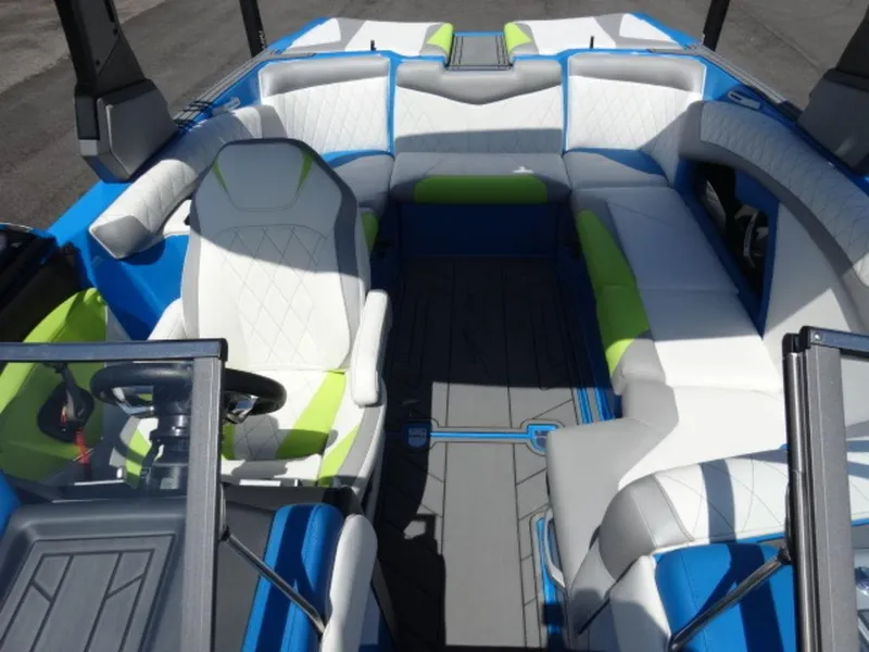 Slide: The Image of 2018 Tigé Z3 boat interior with white, blue, and green seating, featuring a modern design. - 11