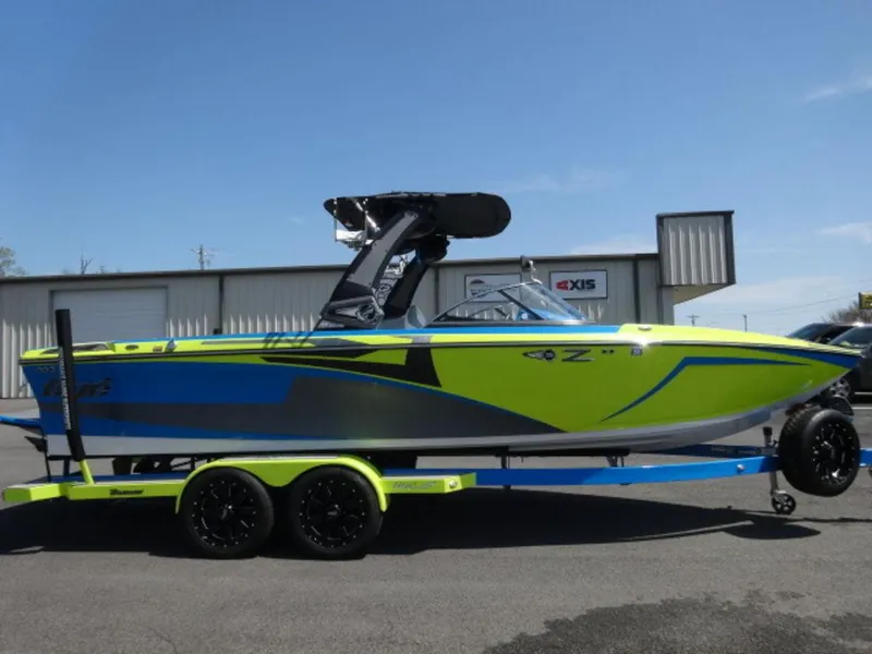 Slide: The Image of 2018 Tigé Z3 boat in vibrant green and blue, parked on a trailer. - 2