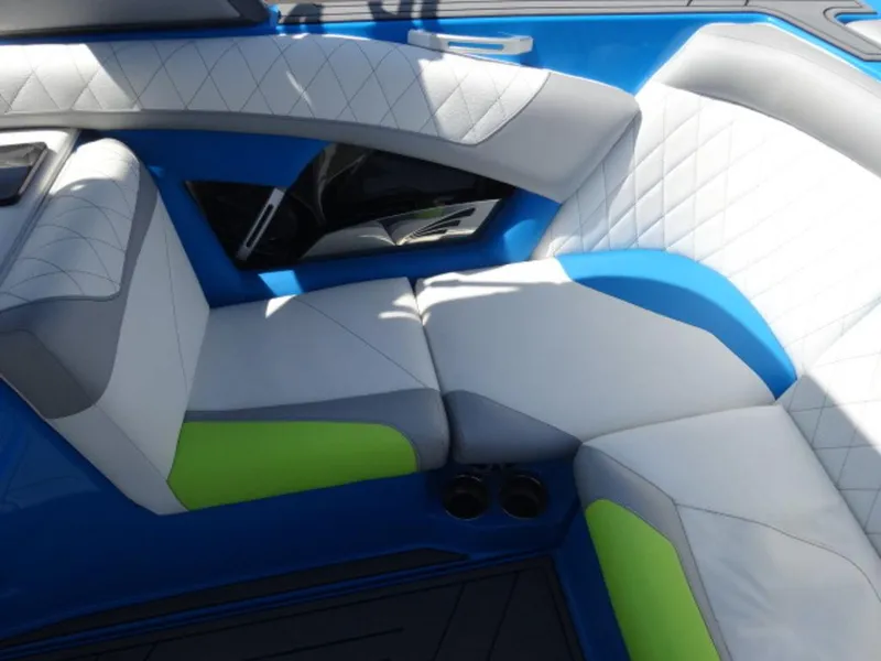 Slide: The Image of 2018 Tigé Z3 boat interior with blue, white, and green cushioned seating. - 6