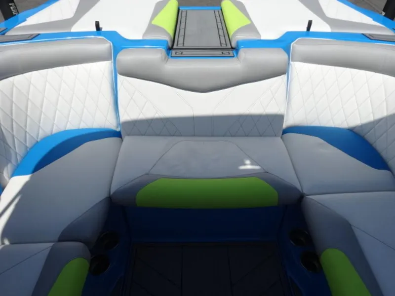 Slide: The Image of 2018 Tigé Z3 boat interior with blue, gray, and green cushioned seating. - 7