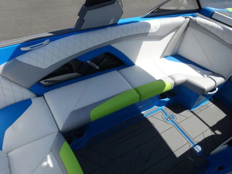 Slide: The Image of 2018 Tigé Z3 boat interior with blue, white, and green seating. - 8
