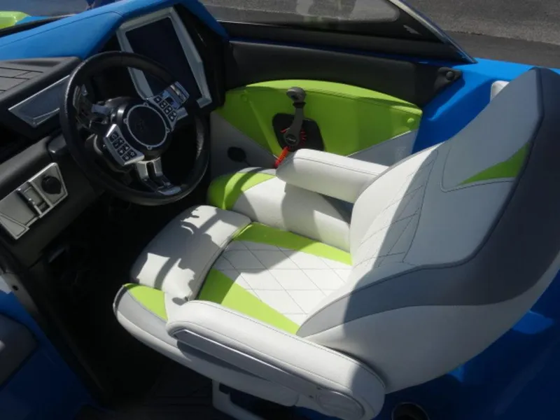 Slide: The Image of 2018 Tigé Z3 boat interior with modern steering and green-accented seating. - 9