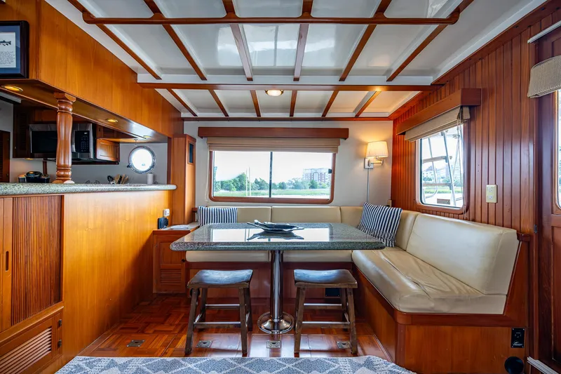 Slide: The Image of Luxurious interior of 2000 Kadey-Krogen 48 North Sea yacht with wood paneling and dining area. - 10
