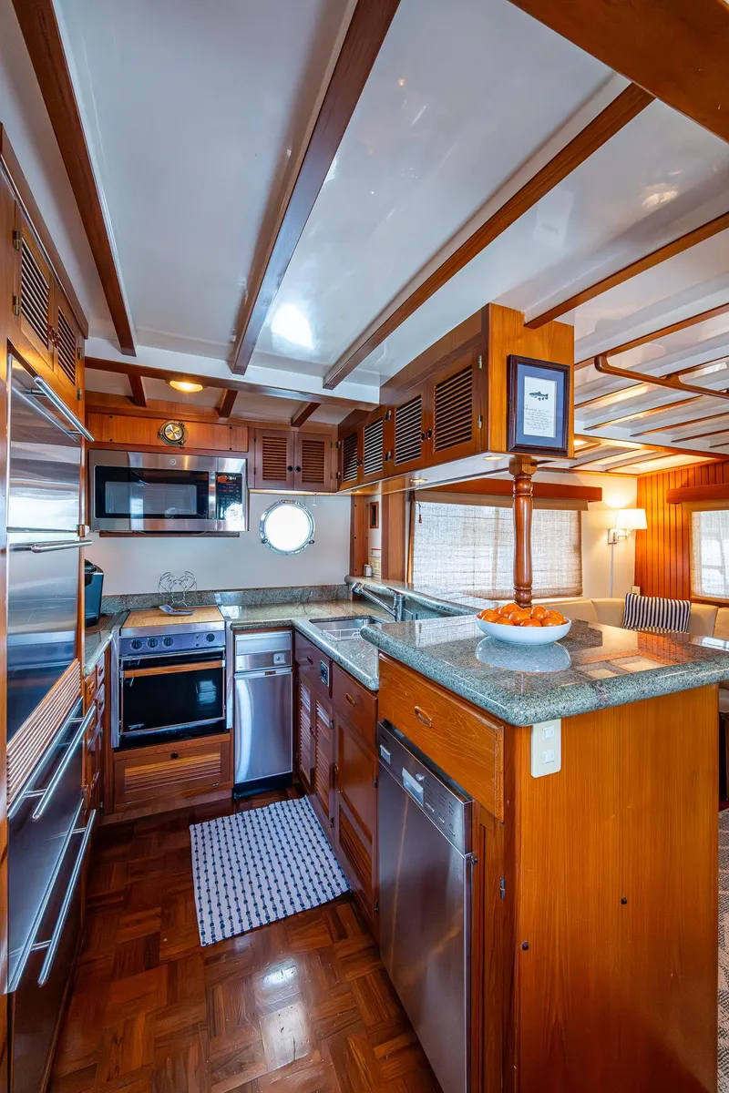 Slide: The Image of Kadey-Krogen 48 North Sea 2000 yacht kitchen with wood finish and modern appliances. - 13