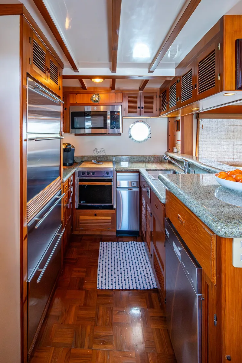 Slide: The Image of Galley kitchen in 2000 Kadey-Krogen 48 North Sea yacht with wood cabinetry and modern appliances. - 14