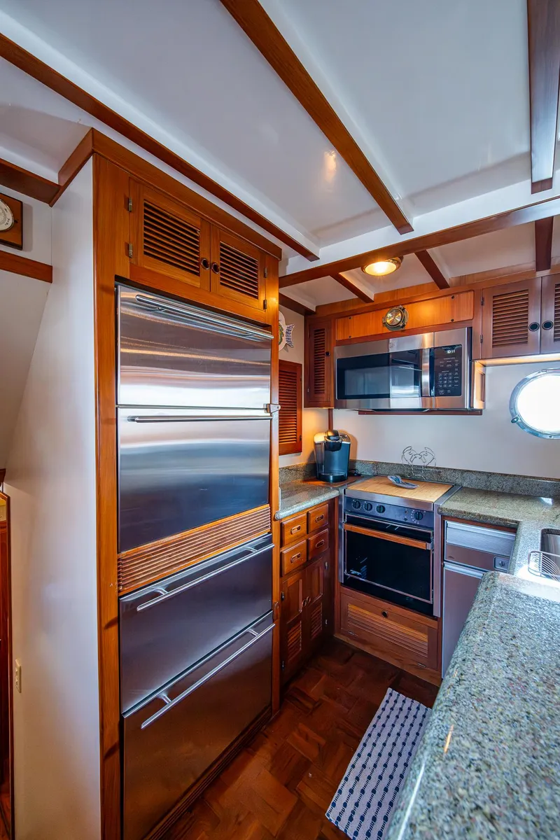 Slide: The Image of Kadey-Krogen 48 North Sea 2000 yacht kitchen with wood cabinetry and modern appliances. - 15