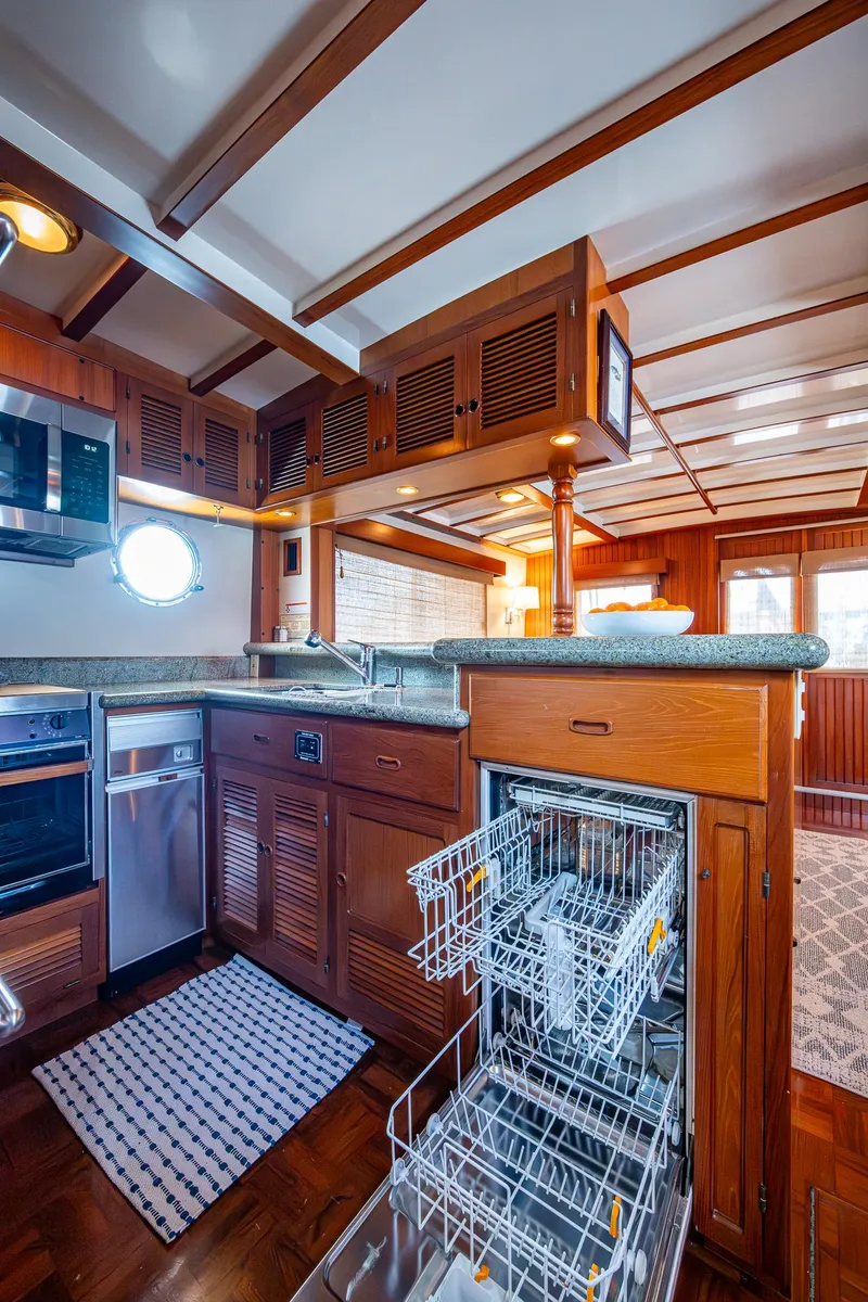 Slide: The Image of Kadey-Krogen 48 North Sea 2000 yacht kitchen with wood cabinetry and modern appliances. - 16