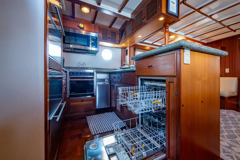 Slide: The Image of Kadey-Krogen 48 North Sea 2000 yacht kitchen with modern appliances and wooden cabinetry. - 17