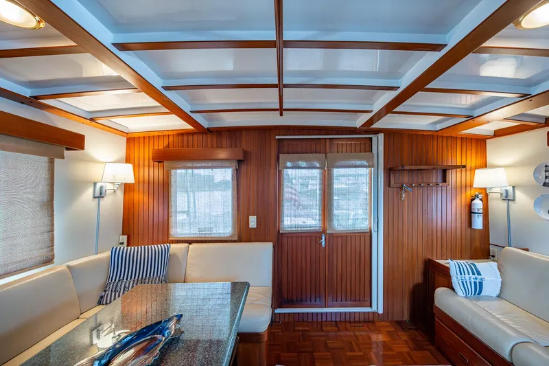 Slide: The Image of Interior of 2000 Kadey-Krogen 48 North Sea yacht with wood paneling and cozy seating area. - 21