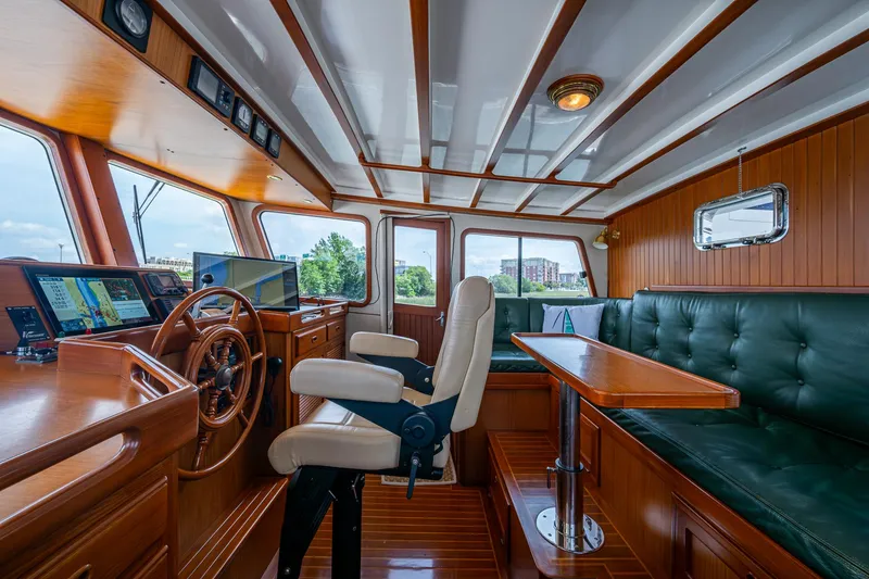 Slide: The Image of Pilothouse interior of 2000 Kadey-Krogen 48 North Sea yacht with wood finish and navigation equipment. - 24