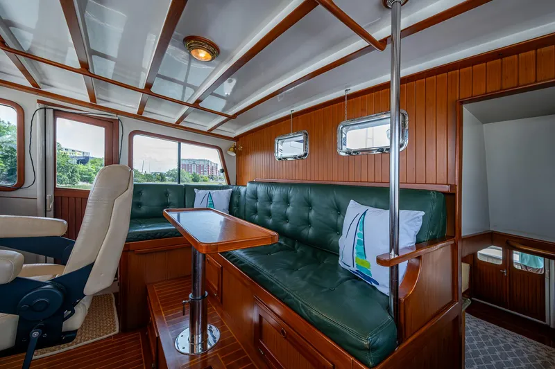 Slide: The Image of Luxurious interior of 2000 Kadey-Krogen 48 North Sea yacht with green leather seating. - 25