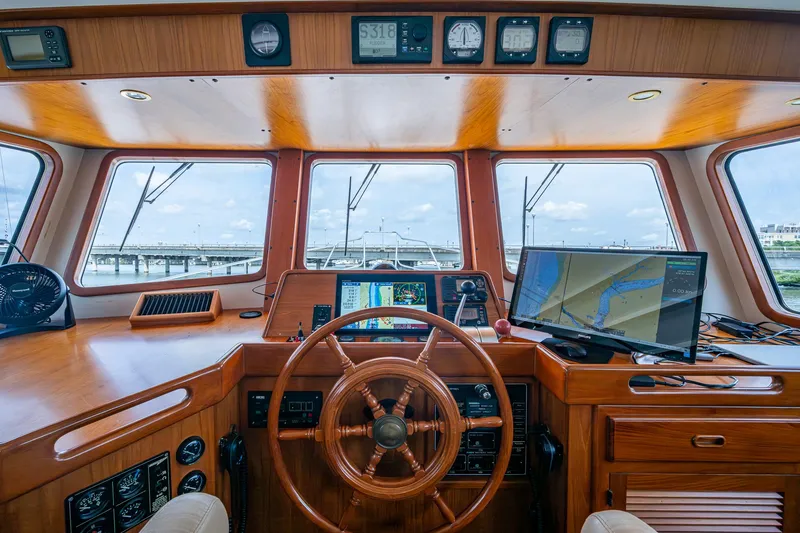 Slide: The Image of Pilothouse of 2000 Kadey-Krogen 48 North Sea yacht with navigation equipment and wooden steering wheel. - 29