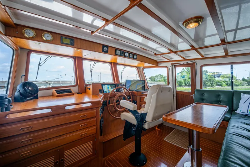 Slide: The Image of Pilothouse interior of 2000 Kadey-Krogen 48 North Sea yacht, featuring wood finishes and navigation equipment. - 31