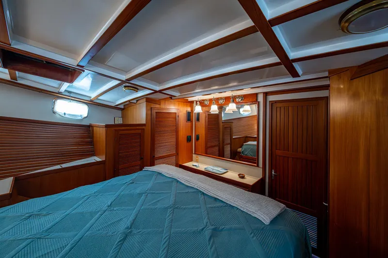 Slide: The Image of Luxurious cabin interior of 2000 Kadey-Krogen 48 North Sea yacht with wood paneling and cozy bed. - 36