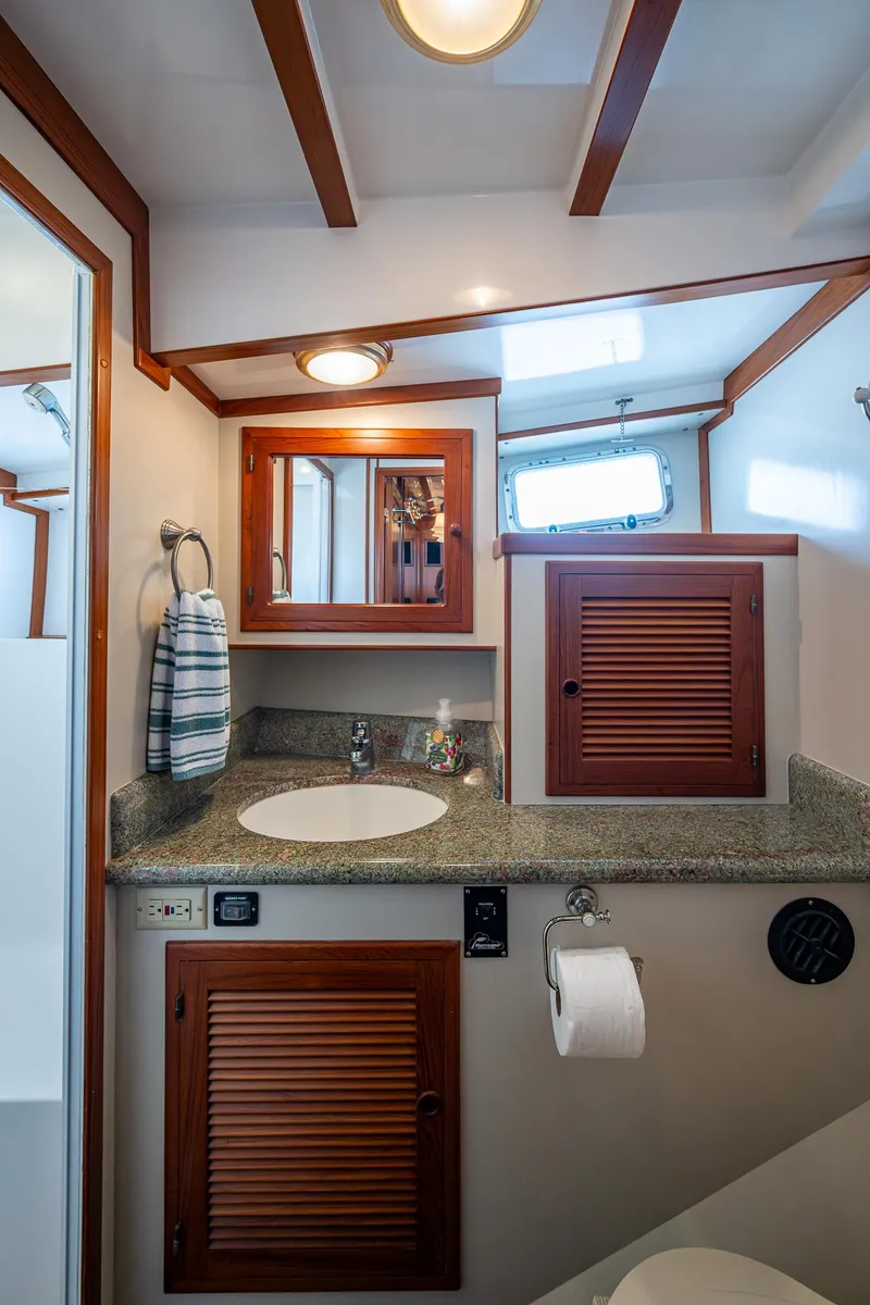 Slide: The Image of Kadey-Krogen 48 North Sea 2000 yacht bathroom with wooden accents and granite countertop. - 39
