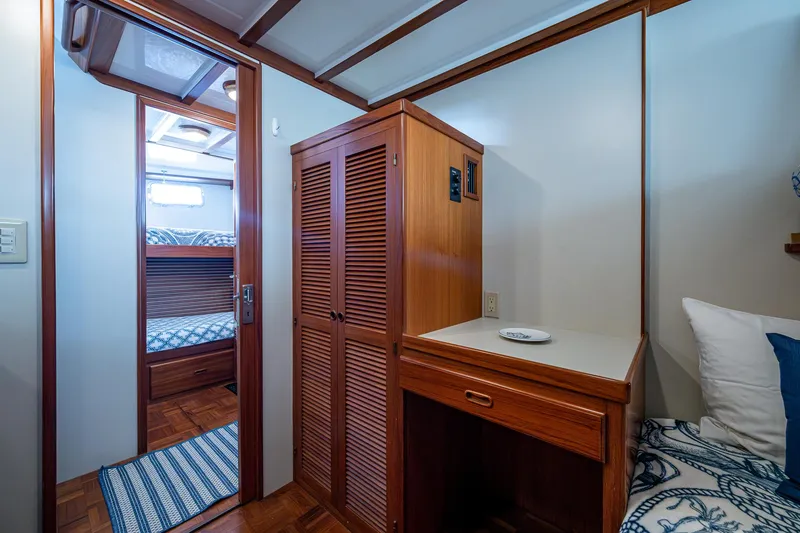 Slide: The Image of Interior of 2000 Kadey-Krogen 48 North Sea yacht with wooden cabinetry and cozy bedding. - 45