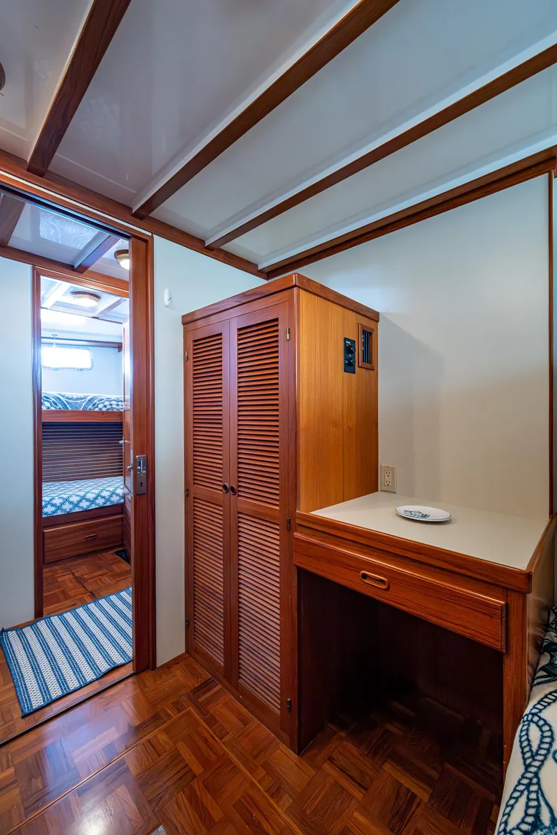 Slide: The Image of Interior of 2000 Kadey-Krogen 48 North Sea yacht with wooden cabinetry and cozy bunk beds. - 48