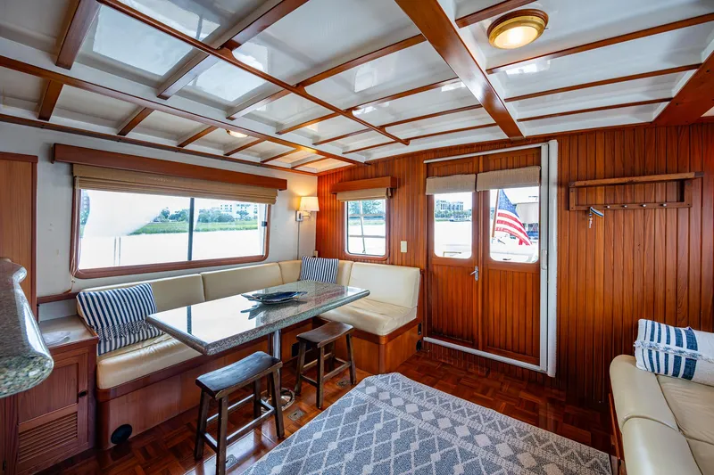 Slide: The Image of Interior of 2000 Kadey-Krogen 48 North Sea yacht with elegant wood paneling and cozy seating. - 9