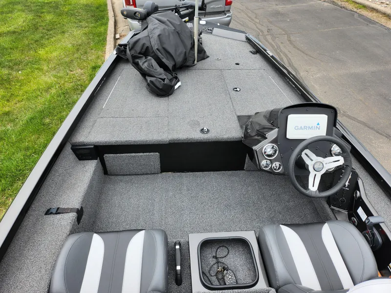 Slide: The Image of 2021 Vexus AVX189 boat interior with Garmin system, gray seating, and storage compartments. - 11